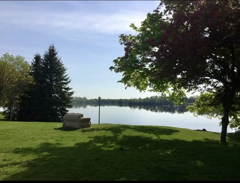 carved indiana limestone loveseat facing lake