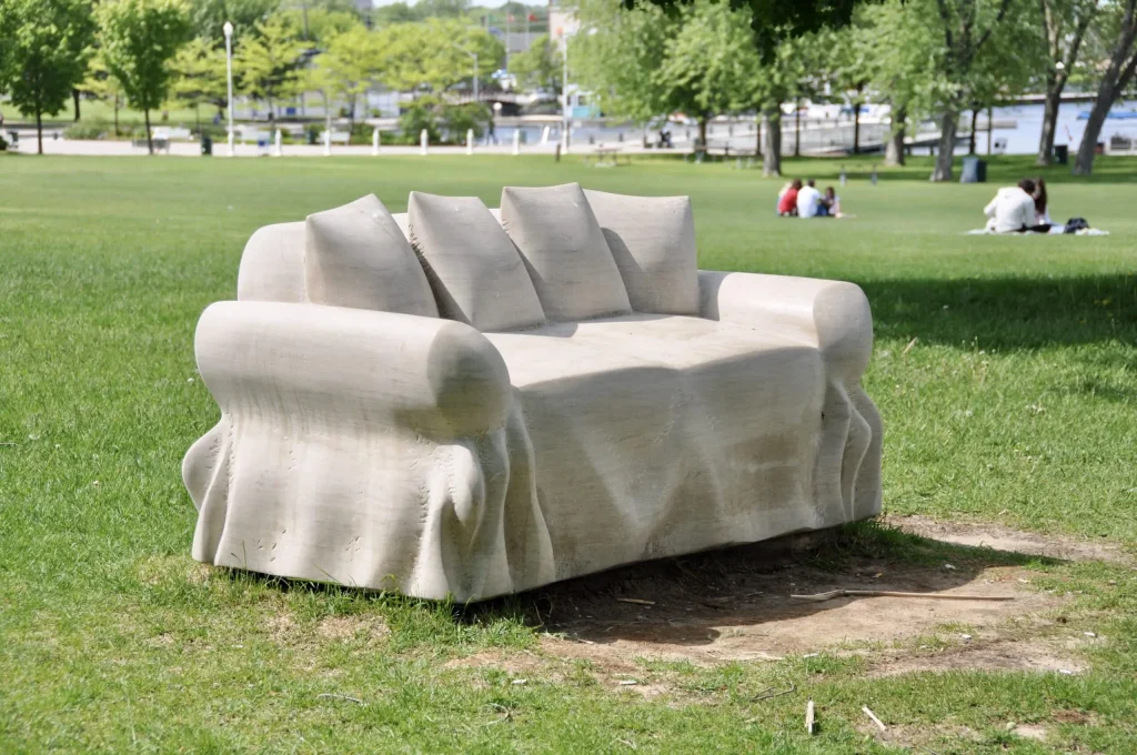 close view of carved limestone loveseat in park by Ernest Daetwyler