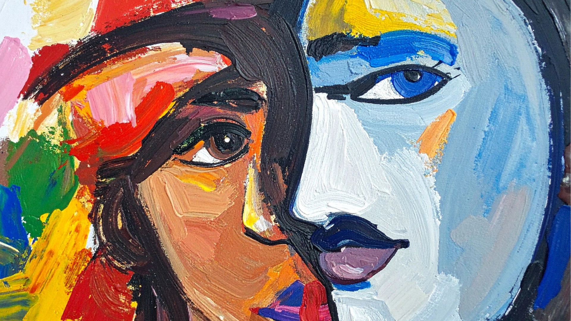 A vibrant abstract painting features two overlapping faces. One face is painted with warm tones, the other with cool blue hues, creating a striking contrast.