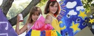 Two children holding the kites they made during an AGP summer kids camp