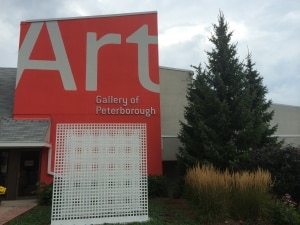 AGP façade featuring Peter Kolisnyk's Three Part Ground screen. Three white grids installed in AGP's front garden.
