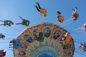 Photograph by Miriam Davidson featuring people riding a ferris wheel swing at a carnival