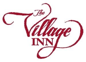 The Village Inn logo. Red text in ornate script.