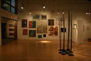 Gallery view of the Triennial exhibition featuring multiple pantings and sculptures installed in the AGP's main gallery