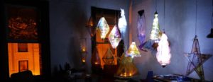 Hand-made stain glass lanterns hanging in a dark room