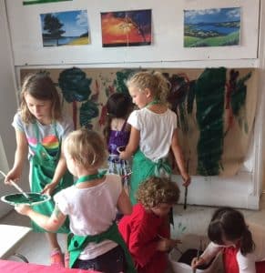 Group of children painting in AGP's studio