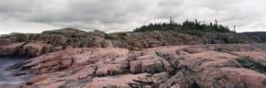 Chromogenic print by Dr. Roberta Bondar featuring pink granite with a pine forrest in the background