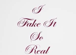 Glitter painting by Chris Ironside. Pink glitter text, cursive font, reading : "I fake it so real."