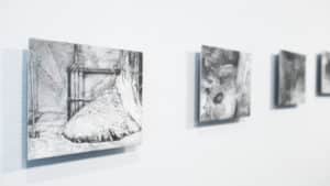 Gallery view of Sasha Opeiko's solo exhibition 217. Graphite drawings on gessoed aluminum featuring a dilapidated nuclear building installed on the AGP ramps.