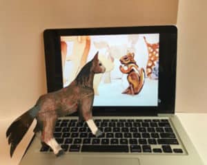 Three dimensional paper collage of a brown horse standing on a laptop keyboard with a brown and white chipmunk on the screen
