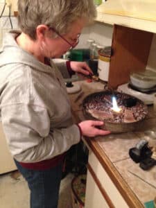 Valerie Davidson working with a blow torch in her studio
