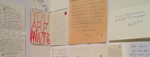 Multiple hand written love letters pinned to a wall. Project by Syrus Marcus Ware.