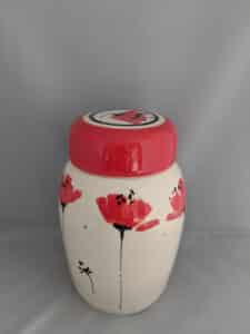 White ceramic jar by Suzanne Woods with red poppies