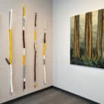 Left: John Boorman, walking sticks, painted carved wood; Right: Stephanie Ford Forrester, Ancestral Sisters #3, 2020, hand worked cotton and batiks