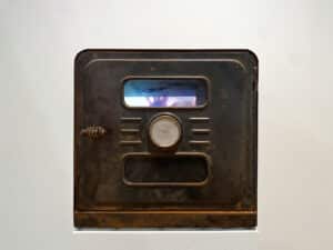 Kelly O'Neill's sculpture of a vintage metal box with a small window installed on plinth in the AGP's main gallery. Video can be seen through the window.