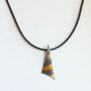 A gray geometric pendant with expressive gold markings.