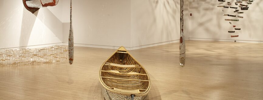 four sculptural works based on canoe forms in a gallery pace