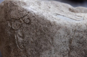 close up view of a rock surface with curvilinear shapes and designs carved into the surface